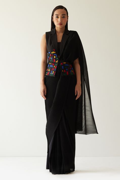 Black pleated based pre-draped saree. Comes with sleeveless Blazer with appliques, quilting and beaded work. Paired with pant and bustier. Component: 4 Pattern: Appliques Type Of Work: Geometric Pattern Neckline: Blazer: Notched Lapel Sleeve Type: Sleeveless Fabric: Crepe, Crinkled Georgette Color: Black Other Details:  Geometric pattern Pre-draped saree Pleated base Occasion: Cocktail - Aza Fashions Saree With Blazer, Blazer Sleeveless, Pant Saree, Dhoti Saree, Formal Saree, Draped Saree, Beaded Work, Drape Pants, Sleeveless Blazer