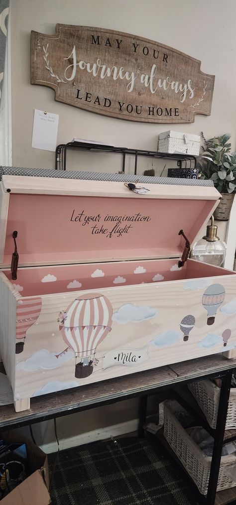 "DESCRIPTION:  This is a 32\" toy chest a 24\" rolling toy box or our new XL 38\" chest that is customized with the child's name on the banner.  The name is done in black    Lid quote is \"Let your imagination take flight\" it comes with this design.   A longer quote can be added under the lid for $14-$30  The toy box is hand crafted & It has a hand-painted Hot air balloon scene with elephant in the basket and roses on it. Hot air balloons are in pinks greys & cream. (Colors can be customized) W Toy Chest Bench Makeover, Painting Toy Chest, Toy Chest Painting Ideas, Toy Box Decoration Ideas, Custom Toy Chest, Vintage Toy Chest, Kids Toy Box Ideas, Wooden Toy Boxes Diy, Painted Toy Box Ideas