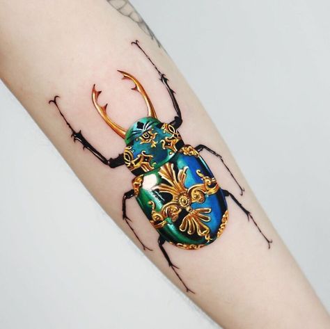 30 Dazzling Golden Tattoos Made With Precision By Manhattan-Based Tattoo Artist Gold Tattoo Ink, Scarab Beetle Tattoo, Scarab Tattoo, Antique Tattoo, Beetle Tattoo, Bug Tattoo, Tattoo Magazine, Gold Tattoo, Glitter Tattoo