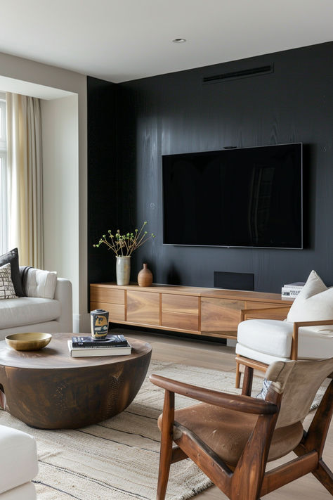 Living room showcasing a black accent wall with a mounted TV, a wooden console, and modern decor pieces Black Wall Living Room Tv, Tv Focal Wall Ideas, Black Accent Wall Tv, Painted Tv Wall, Black Accent Tv Wall, Tv Focal Wall, Focal Wall Ideas, Accent Tv Wall, Black Walls Living Room