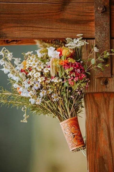 Choose a more rustic-style bouquet for your western wedding, with wildflowers to boot. To take it one step further? A leather wrap to hold your blooms in place makes for such a charming touch. Find more western wedding ideas we love at the link. // Photo: Whiskey Jain Leather Company Whimsical Western Wedding, Bright Western Wedding, Spring Wedding Western, Western Wedding Alter, Western Wedding Spring, Western Wildflower Wedding, Summer Western Wedding, Western Wedding Bouquets, Western Spring Wedding