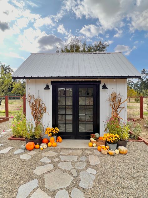 Garden Shed decorated for fall. Pumpkins, mums, and dried corn. Flagstone walk way. Storage Shed Laundry Room, Behind Shed Ideas, Farmhouse Garden Shed, Small Yard Makeover, Stone Shed Conversion, Metal Garden Shed Makeover, Dog Shed House, Garden Shed Fall Decor, Laundry Shed