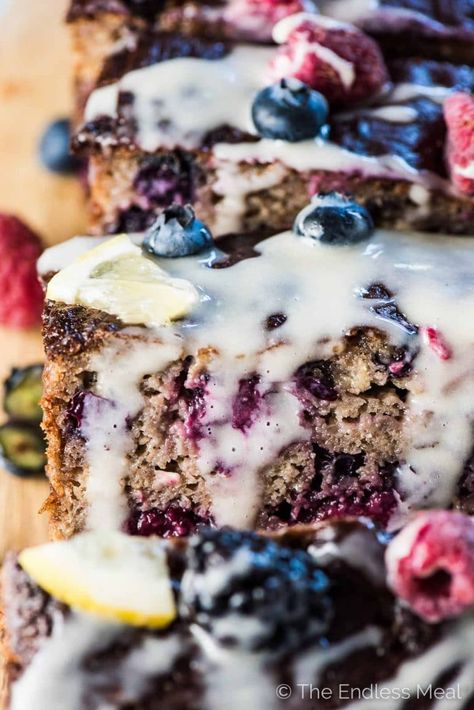 Triple Berry Paleo Banana Bread is a crazy delicious yet super healthy dessert recipe. It's packed full of good for you ingredients like bananas, eggs, almond flour, collagen, and fresh berries. I like to eat a big slice for breakfast with my cup of coffee. | paleo + gluten-free + refined sugar free | Grape Muffin Recipes, Concord Grape Recipes, Greek Yogurt Blueberry Muffins, Jordan Marsh Blueberry Muffins, Blueberry Yogurt Muffins, Paleo Banana Bread, Grape Recipes, Paleo Banana, Blueberry Muffins