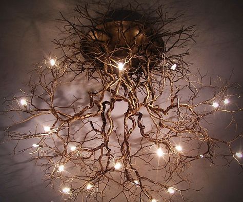 Take an interior decorating cue from Mother Nature herself by illuminating your home with this tree roots ceiling lamp. This work of art features a pewter wire design resembling an interconnected web of roots with light bulbs scattered all throughout the structure. Driftwood Log With Lights, Ceiling Fairy Forest Lights, Tree Branch Chandelier Living Room, Tree Chandelier Modern, Driftwood With Fairy Lights, Luminaire Original, Deco Luminaire, Tree Roots, Natural Home Decor