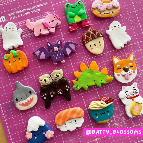 You asked for fridge magnets and here they are! I present to you a whole menagerie of cute clay friends to decorate your fridge (or anywhere else that's magnetic..) These little magnets are all handmade using polymer clay and all hand painted by me. They are perfect for brightening up your kitchen and make excellent little gifts! Choose from one of 22 bright and cheerful designs: Acorn Axolotl Bat Bee Blossom Capybara Cloud Daffodil Doughnut Frog Fuji (mountain) Ghost Lucky Cat Otters Pumpkin Ramen Bowl Red Panda Shark Shiba Inu (dog) Stegosaurus Sushi Toadstool Magnets are unpainted on the reverse with a strong magnet superglued to them. They are sealed with a layer of glossy varnish. What will I receive? 1 x handmade clay magnet. Please note - due to the handmade nature of this product, Magnet Ideas Fridge, Halloween Clay Magnet Ideas, Cute Clay Magnet Ideas, Easy Clay Magnets, How To Make Fridge Magnets, Oven Bake Clay Magnets, Cute Magnets For Fridge, Simple Clay Crafts, Clay Magnets Diy Fridge