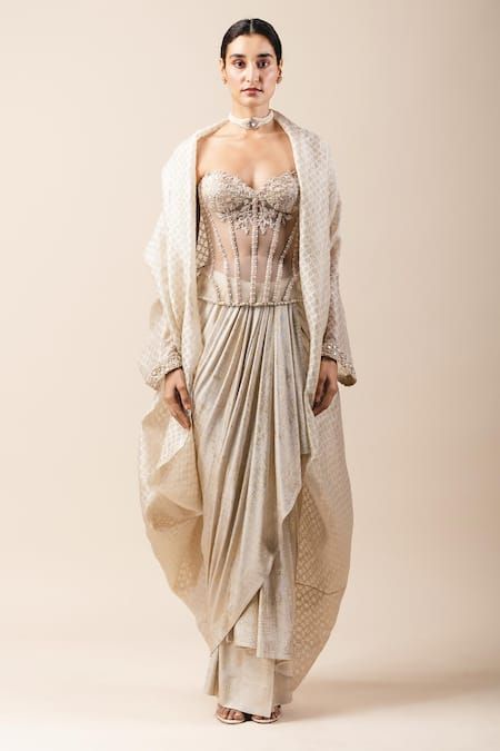 Buy White Foil Jersey Sweetheart Neck Balloon Cape And Draped Skirt Set For Women by Tarun Tahiliani Online at Aza Fashions. White Fitted Set With Cape Sleeves, Embroidered Draped Sets For Wedding, Elegant Sets With Draped Long Sleeves, Elegant Long Sleeve Sets With Draped Sleeves, Traditional Fitted Cape Dress, Fitted Sets With Draped Sleeves For Wedding, Fitted Wedding Sets With Draped Sleeves, Elegant Designer Dresses With Draped Sleeves, Elegant Designer Lace Dresses