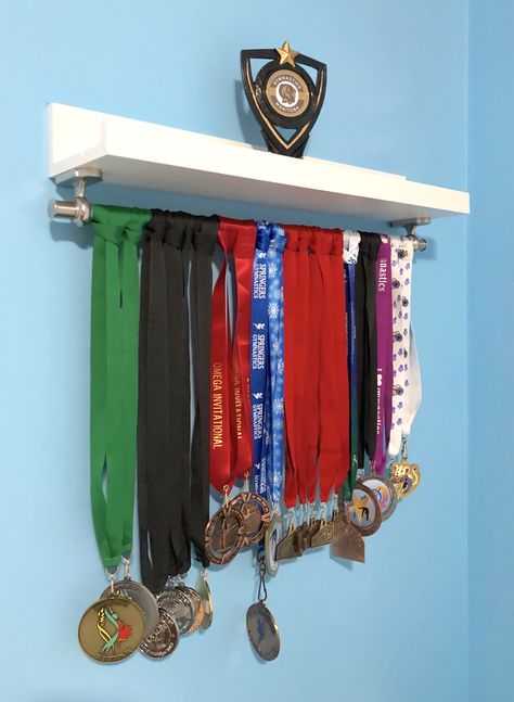 DIY gymnastics medal display made with Ikea Mosslanda picture ledge and Fintorp Kitchen Rail. Gymnastic Medal Display Ideas, Medal Holder Ideas Diy, Medal Holder Diy, Medal And Certificate Display Ideas, Medal Holder Ideas, Medal Display Ideas Diy, Runner Medal Display, Medal Display Ideas, Cheer Room