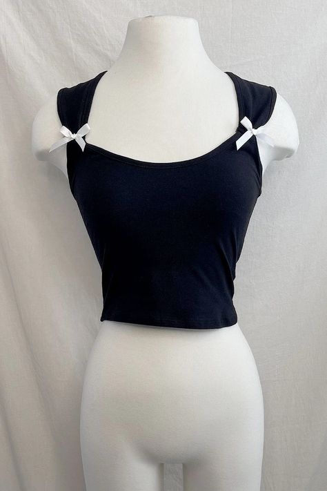 Slip into playful elegance with our Alanis Coquette Bow Top! The cropped sleeveless design features charming ribbon detailing on the side, adding a touch of coquettish flair. Perfect for a night out or a fun day with friends. Sleeveless Ribbon bow details Cropped Stretchy Imported 97% Cotton, 3% Polyester True to size Coquette Crop Top, Tops With Bows, Youtuber Dr, Coquette Top, Ribbon Top, Day With Friends, Dr Closet, Bow Top, Coquette Bow