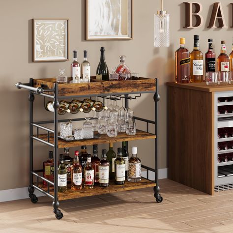 PRICES MAY VARY. Stylish Appearance Design: The vintage bar cart with unique roman column designs on the side pillars and handles, making the entire bar cart for the home more vintange and fashionable. The home bar & serving cart matches with your home decor easily in the living room, kitchen, or dining room. Large Storage Space: This bar cart is 15.7"D x 35.4"W x 34.1" H, comes with 3-tier shelves to store snacks, beverages, or kitchen supplies. The bar cart with wine rack and glass holders, wh Portable Home Bar, Rustic Bar Cart, Industrial Bar Cart, Cart Bar, Snack Cart, Wine Cart, Living Room Retro, Bar Serving Cart, Wood Bar Cart