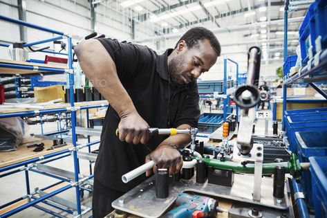 Male skilled factory worker, a man holding a tool, working to assemble parts of a bicycle in a by Mint_Images. Male skilled factory worker, a man holding a tool, working to assemble parts of a bicycle in a factory. #Sponsored #worker, #man, #holding, #Male Factory Worker, A Man, Hold On, Bicycle, Mint, Tools, Quick Saves