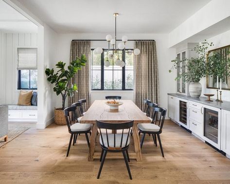 Black spindle chairs at a brown reclaimed wood dining table in a charming modern farmhouse dining space. Neutral Dining Room With Pop Of Color, Mixed Wood Dining Table And Chairs, Scandi Dining Room, Front Foyer, Modern Farmhouse Dining Room, Black Chairs, Transitional Dining Room, Modern Farmhouse Dining, Reclaimed Wood Dining Table