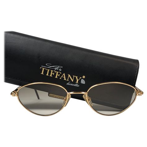 New Tiffany gold plated cat eyes frame. Spotless brown gradient lenses. Made in Italy. Produced and design in 1990's. This item may show minor sign of wear due to storage. 1960s Sunglasses, 1970s Sunglasses, Tiffany Gold, Tiffany Rose, Black Round Sunglasses, Vintage Tiffany, Sunglasses Logo, Designer Glasses, Chanel Sunglasses