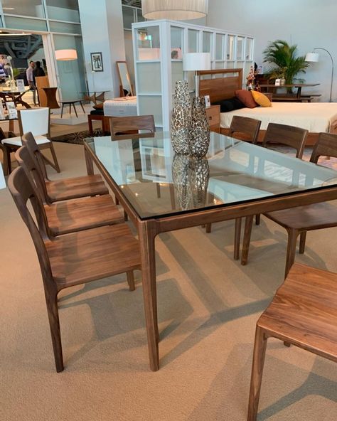 The Lisse Dining Collection is the perfect marriage of modern and classic design. Crafted from solid walnut, this features graceful curvature with its molded and sculptural lines. A glass top brings a modern sensibility to the table, while the solid base provides the perfect foundation for this finely crafted piece. Photo by: PerLora Furniture @perlorahome Glass On Wood Table, Wood Base Glass Top Dining Table, Bedroom Inspiration Grey, Wood Dining Table Modern, Couches Living, Round Dining Table Sets, Dinning Room Design, Wooden Dining Table, Table Glass