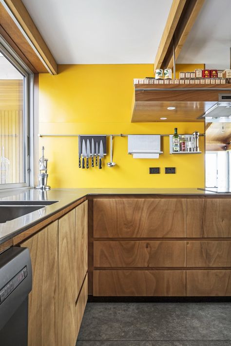 Photo 5 of 9 in This Bunker-Like Home in New Zealand Fights Back Against Howling Winds Off Lake Wanaka - Dwell Kitchen Yellow Black, Yellow Kitchen Splashback, Yellow Kitchen Walls With Wood Cabinets, New Zealand Interior Design, Yellow And Wood Kitchen, Cabinet Dishwasher, Yellow Kitchen Walls, Kitchen Yellow, Yellow Floor