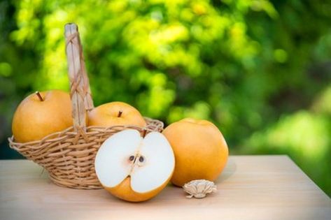 Snow pear or Fengsui pear on the brown wooden table in garden,Fresh Korea pear fruit. Korea pear fresh fruit in the basket  on natural farm background Table In Garden, Snow Pear, Farm Background, Garden Organization, Pear Fruit, Lr Preset, African Food, Wooden Table, Wooden Tables