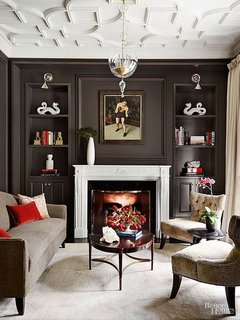 High-contrast paint colors provide an interesting interplay of dark and light in this architecturally rich study. Coffee-brown paint enhances the presence of the paneled fireplace wall. Bright white finishes highlight the mantel's shape and carved details, as well as the elegantly embellished ceiling. White crown molding works with the white ceiling to reflect light and make the walls appear taller. / Fireplace Styles, Traditional Family Room, Color Palette Living Room, Room Dark, Crown Moldings, Dark Walls, Family Room Design, Living Room Storage, A Living Room