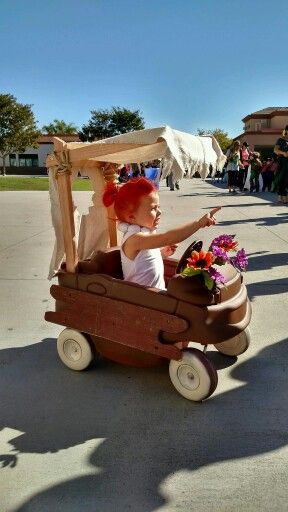 Wilma and her Flintstones car. Trying to sell this car now that it is halloween time. Any one know what they would pay for the car? Just curious before we post it on Craigslist. Flinstone Car Diy Wagon, Flinstones Wagon Diy, Diy Flintstone Car Wagon, Flintstones Car Diy, The Flintstones Costumes, Pebbles Costume Toddler, Pebbles Halloween Costume, Flintstone Car, Pebbles Flintstone Halloween Costume