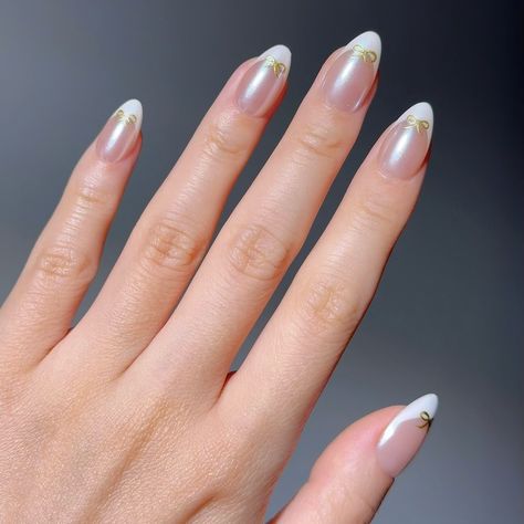 ⚜️Elegance Bound- 👸These premium handmade press-on nails showcase a sophisticated twist on the classic French tip, featuring a subtle pearlescent base and adorned with delicate golden bows, adding a touch of refined charm and elegance. Classic French Tip, Golden Bow, Press On Nails, Twist, Nails, Quick Saves