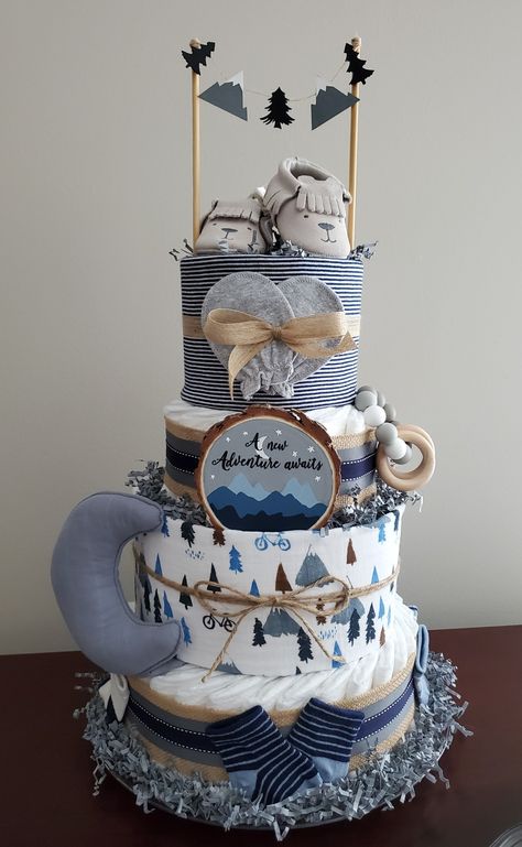 Visit my Facebook page for more pictures and orders. https://m.facebook.com/adorablegifts Includes 75 diapers, 2 receiving blankets, moon security blanket, 3 pair of socks, 1 teether, 1 pair of bear moccasins, customized wood piece. Bear Diaper Cakes For Baby Boy, Creative Diaper Cakes, Nappy Cake Ideas, Teddy Bear Diaper Cake, Diaper Cake Ideas, Baby Boy Diaper Cake, Elephant Diaper Cake, Pamper Cake, Creative Baby Shower Gifts