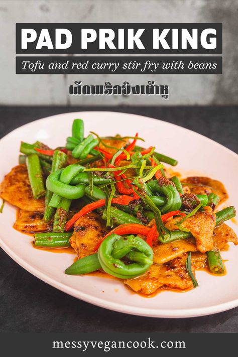 the image is taken at a slight angle from above. Light pink oval melamine plate on a black background. Plate contains thinly sliced pieces of seitan stir fried with long (green) beans. Some of the beans are tied into knots. Red oil pools around the plate. Prik King Recipe, Pad Prik King Recipe, Pad Prik King, Pad Prik, Vegan Thai Curry, Thai Vegan, Thai Stir Fry, Ethnic Food, Vegan Curry