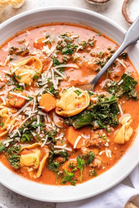 This Vegan Tortellini Soup is the perfect cozy soup to enjoy a big bowl of during the winter months. It’s a brothy soup filled with cheesy tortellini, vegan sausage, Italian herbs, creamy coconut milk, and tons of freshly chopped kale! Brown the sausage and onions, then let the slow cooker work its magic. Brothy Soup, Vegan Tortellini, Sausage Italian, Cheesy Tortellini, Vegan Ravioli, Creamy Tortellini Soup, Spinach Tortellini Soup, Vegan Tomato Soup, Chopped Kale