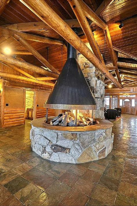 Round, open fireplace - Timber Moose Lodge, Utah Indoor Open Fireplace, Restaurant Fireplace Design, Round Fireplace Indoor, Fireplaces 2023, Fire Pit With Chimney, Restaurant Fireplace, Indoor Wood Burning Fireplace, Round Fireplace, Lottery Dreams