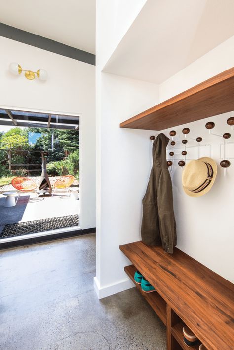 Serving as a transitional area to the back yard, the mud room’s custom shelving echoes the walnut touches found throughout the kitchen. Mid Century Renovation, Mid Century Modern Renovation, Mod Furniture, Mudroom Entryway, Blue Backsplash, Modern Renovation, Custom Shelving, Mudroom Design, Terrazzo Flooring