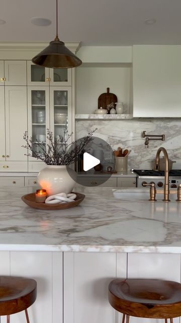 120K views · 13K likes | Amy E Peters | Home Decor on Instagram: "FAQ - Kitchen Addition:  Counters: Island, Backsplash + Shelves: Honed Calcatta Vagli gold Marble Cooktop + Pantry counters: Vicostone Volakano BQ885 quartz. We opted for two different counter materials for a couple reasons - to save cost AND since we are new to having Marble in our kitchen, we wanted to have some kitchen surface that was easy to maintain. We are really happy with our selections - it is practical for us, saved $ and it isn’t really noticeable until I point it out.  Kitchen + Pantry Cabinet Colour: Natural Cream by @benjaminmoore Wall colour: White Dove by @benjaminmoore Custom Range Hood made by @outoflinedesigns  Hardware:  @rejuvenation Pendants: @rugandweave  Let me know if I’ve missed anything!" Calcutta Kitchen, Countertop With Backsplash Lip, Marble Kitchen Backsplash, Calcutta Gold Porcelain Countertops, Calacatta Supreme Gold Quartz Countertops Kitchen And Backsplach, Unique Calacatta Gold Quartz, Calacatta Gold Kitchen, Cream Cupboards, Arabescato Vagli Marble Kitchen