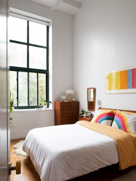 white bedroom with colorful accents Brooklyn Bedroom, Mid Century Colorful, Insta Famous, Colorful Bedroom, Danish Dining Chairs, Brooklyn Apartment, Plywood Chair, White Linen Bedding, Apartment Tour