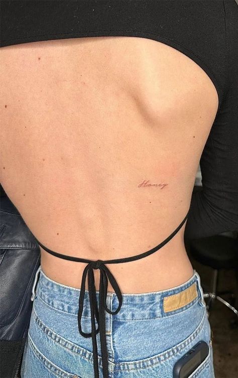 Small Subtle Tattoos For Women, Tattoo Written Words, Small Writing Back Tattoo, Light Word Tattoo, Honey Red Ink Tattoo, Rare Word Tattoos For Women, Many Tattoos On Arm, 4 Letter Word Tattoo, Micro Word Tattoo