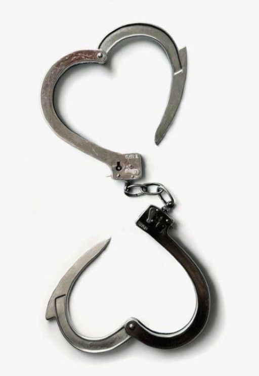 a metal hook with two hearts attached to it's end, on a white background