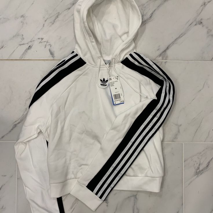 Nwt Women’s Adidas Cropped Hoodie White Athleisure Hoodie With Three Stripes Branding, White Winter Sweatshirt With Three Stripes Branding, Winter White Sweatshirt With Three Stripes Branding, Trendy White Hoodie With Ribbed Cuffs, White Three Stripes Sweatshirt Athleisure, White Three Stripes Athleisure Sweatshirt, White Three Stripes Sweatshirt In Athleisure Style, White Long Sleeve Sweatshirt With Three Stripes, White Long Sleeve Hoodie With Three Stripes