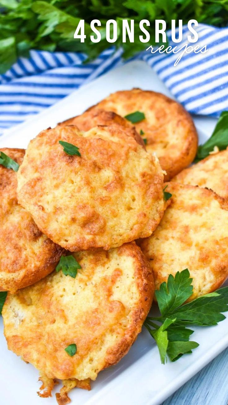 four crab cakes on a white plate with parsley