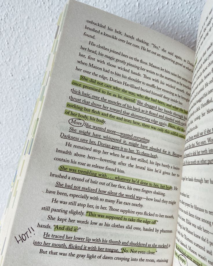 an open book with some writing on the page and green marker in it's center