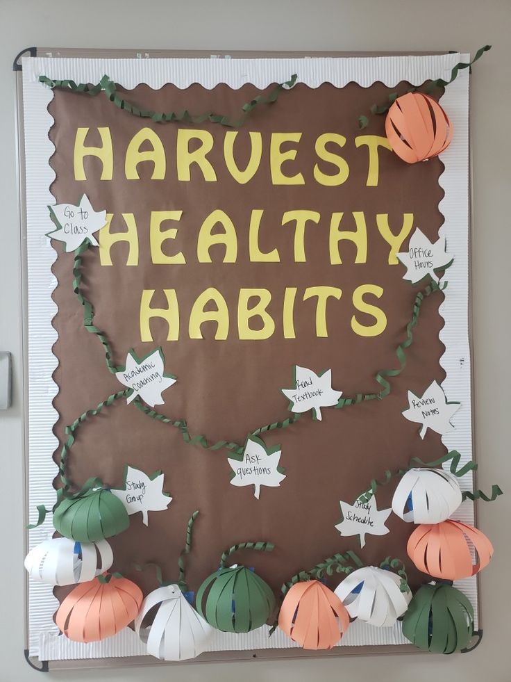 a bulletin board with paper pumpkins and leaves on it that says harvest healthy habitts