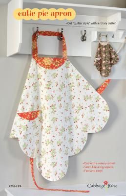 two aprons hanging from hooks on a wall with an orange and white flowered design