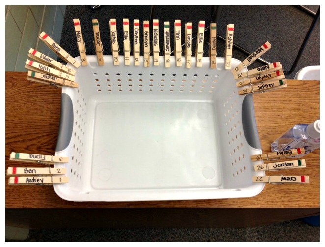 a white tray filled with lots of wooden matches on top of a table next to a cup