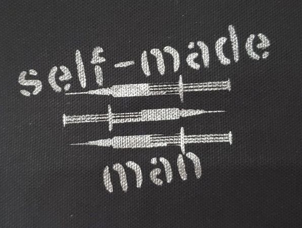 the words self - made man written in white ink on a black background with two swords