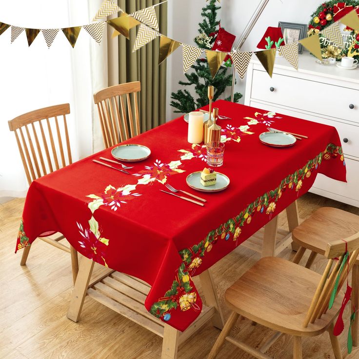 a red table cloth with christmas decorations on it