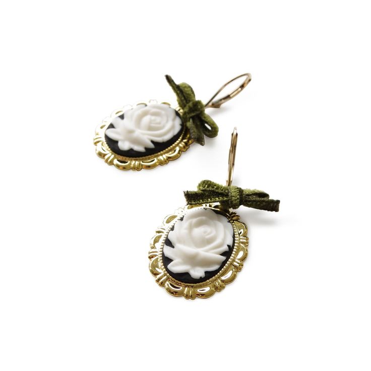 These rose cameo earrings are not only a fashion piece, but also an art piece. The cameos are carefully handcrafted and hand-painted from fine white porcelain. They experienced more than 15 hours kiln firing, with temperatures reaching over 1200°C. The earrings feature a dark romantic look with the black and gold tone finish and the highlighted olive green velvet ribbon bows. Earrings come with 14K gold-filled leverback ear hooks.Handmade porcelain cameos14K Gold-filled leverback ear hooksGold p Green Velvet Ribbon, Bows Earrings, Olive Green Velvet, Cameo Earrings, Dark Romantic, Handmade Porcelain, Porcelain Jewelry, Kiln Firing, Romantic Look