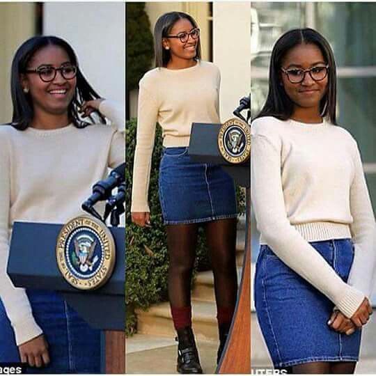 the first lady is wearing a skirt and sweater