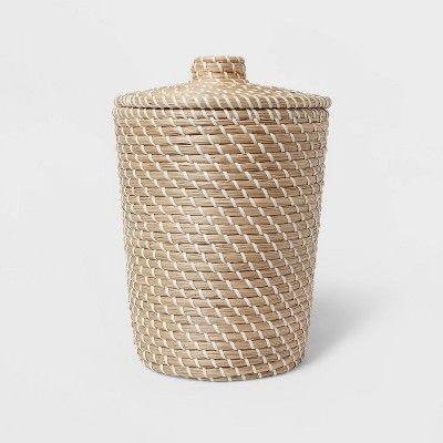 a large woven basket with lid on a white background