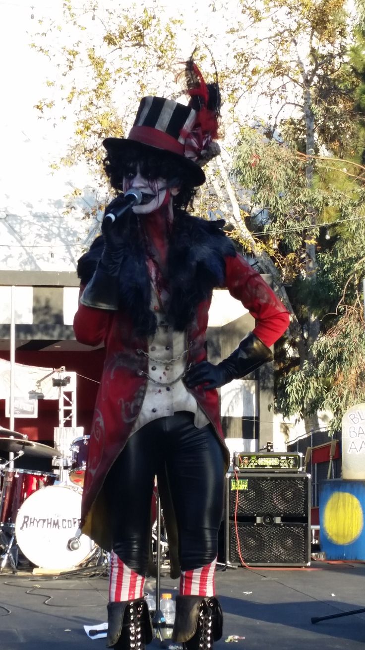 a person in costume riding a scooter on the street