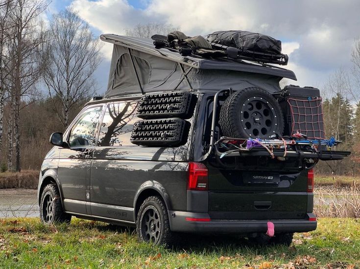 the van is parked on the side of the road with it's roof open