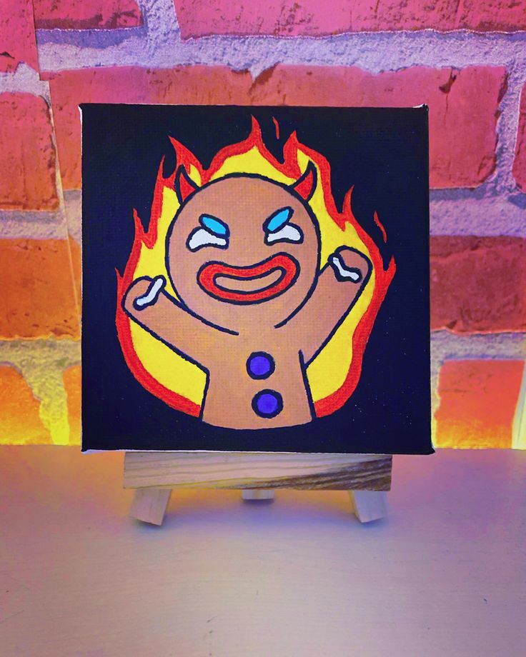 a painting of a fire man on a small wooden stand in front of a brick wall