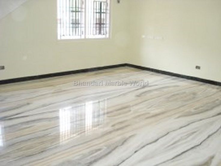 an empty room with white walls and marble floors