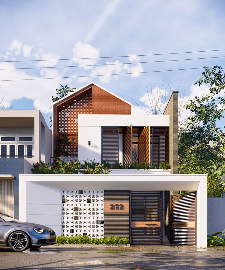 a car is parked in front of a two story house with plants on the roof