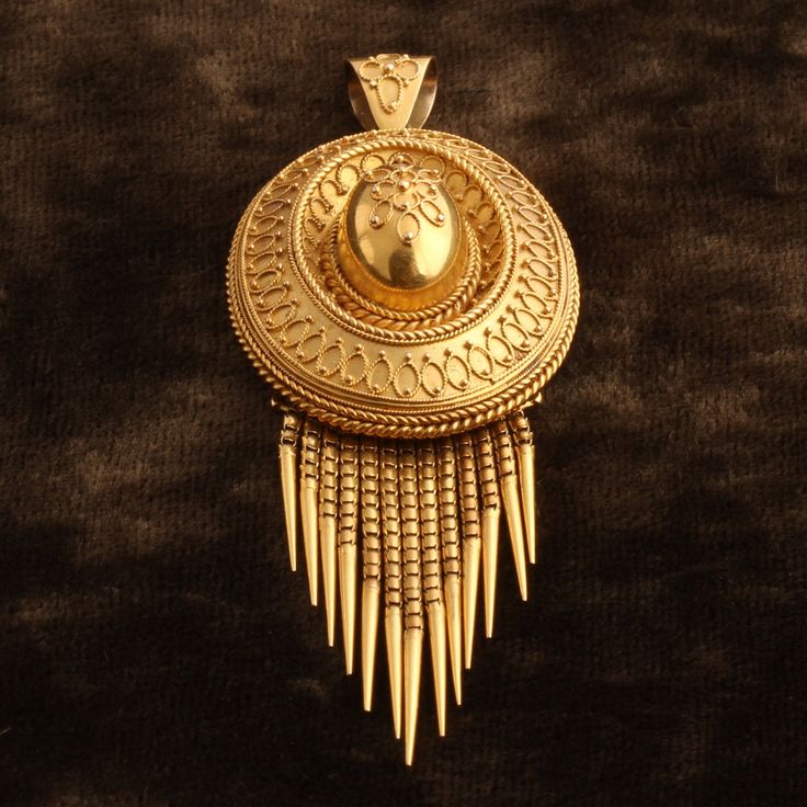 This Victorian era locket was made in the "archaeological style", that is, inspired by the jewelry found in the excavated ruins of ancient Etruscan cities. These newly discovered artifacts were a thing of wonder, and Victorian-era jewelers rushed to reproduce the masterful goldsmithing techniques of the Ancient Etruscan jewelers. Specifically, the filigree and granulation (little balls) were the definitive Etruscan look. Even now, modern jewelers struggle to understand how the ancient jewelers d Ancient Style Yellow Gold Brass Jewelry, Ceremonial Amulet Jewelry With Large Pendant, Ritual Amulet Pendant Jewelry, Amulet Pendant Jewelry For Rituals, Gold Oval Jewelry With Historical Design, Ceremonial Medallion Jewelry With Historical Design, Traditional Medallion Jewelry For Ceremonial Occasions, Traditional Yellow Gold Oval Pendant Jewelry, Ceremonial Hallmarked Bronze Jewelry