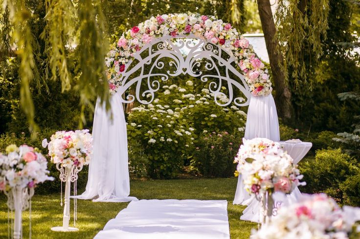 an outdoor wedding setup with white and pink flowers