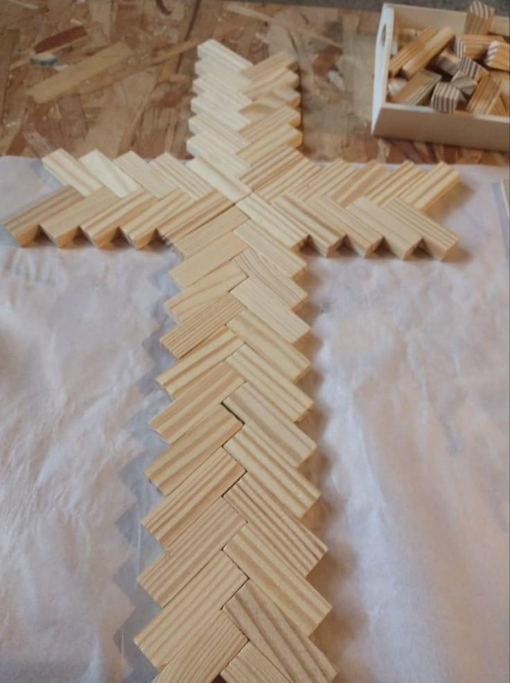 a cross made out of wooden planks sitting on top of a table